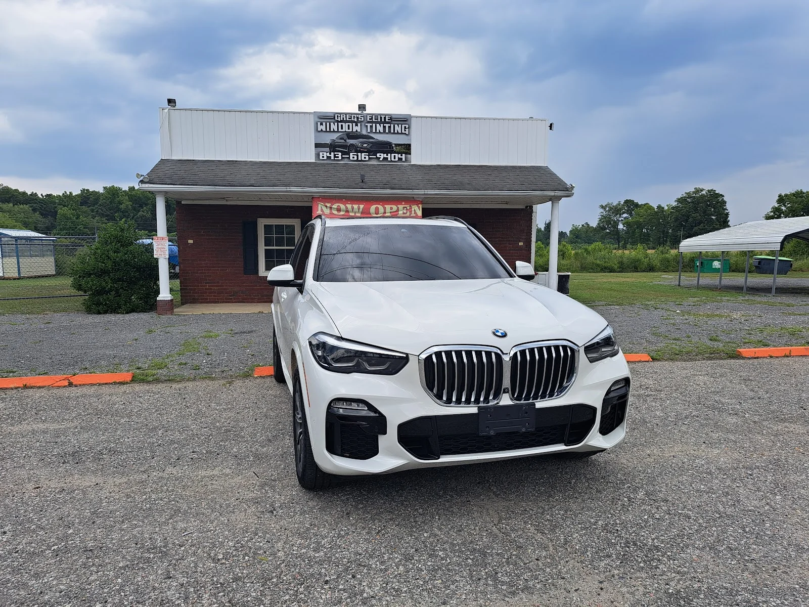 Inside Greg's Elite Window Tinting — shop interior and work bay